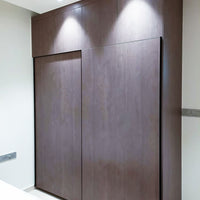 Dark laminate wardrobe with loft cabinets