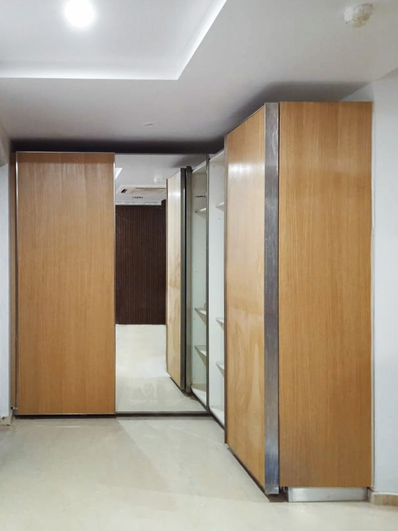 Wooden modular wardrobe with sliding mirror door.