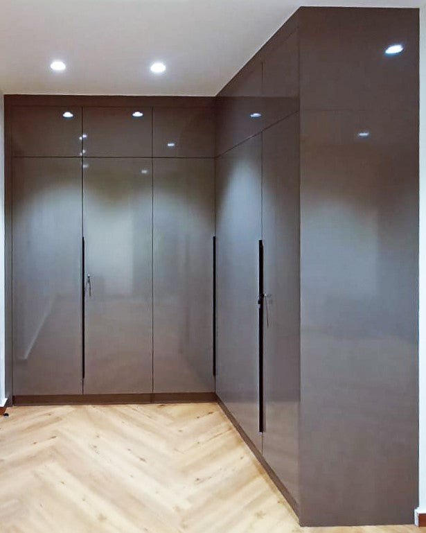 Glossy brown L-shaped modular wardrobe with handle-free design.