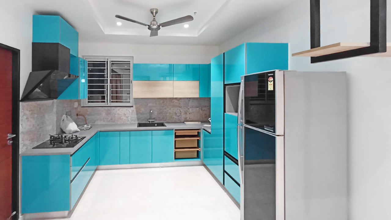 Bright blue kitchen with modern appliances and sleek cabinets.