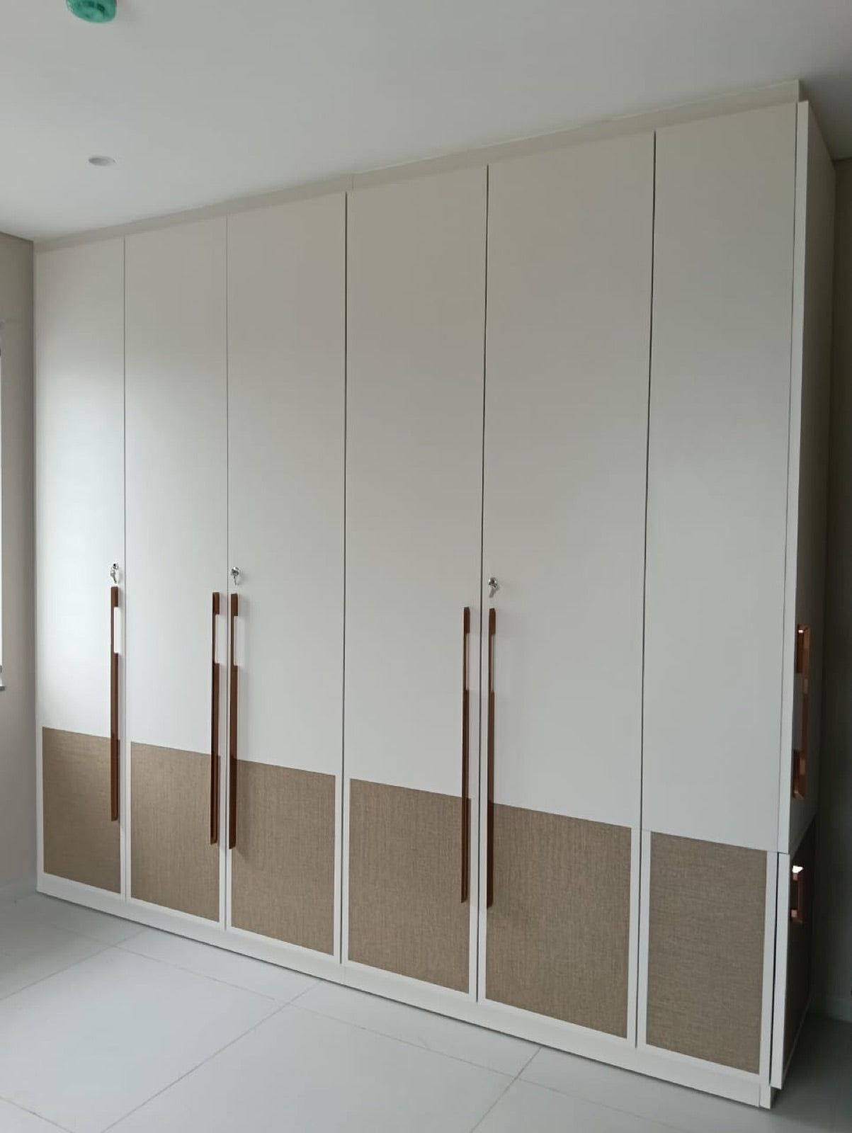 Six-shutter wardrobe · cream with tan fabric-panel accents