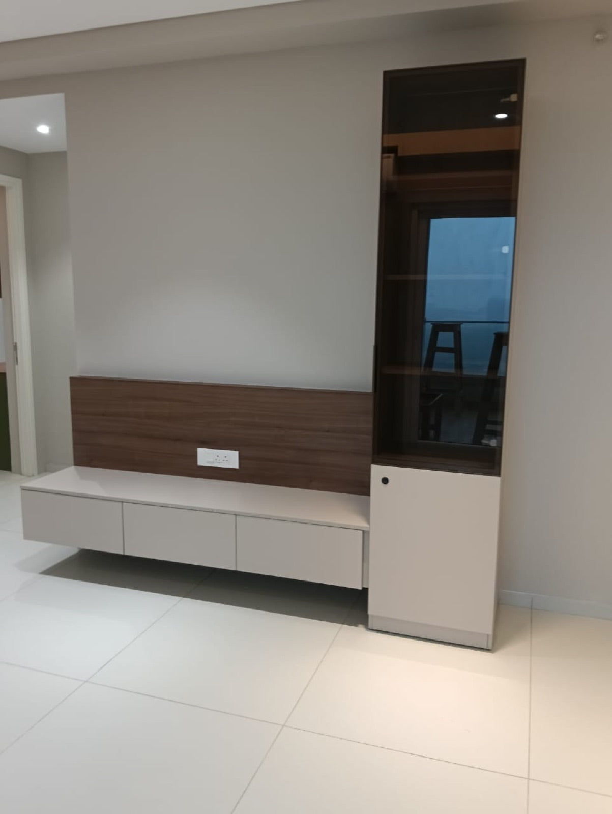 Living room TV unit · floating cabinet with tall glass-front display cabinet