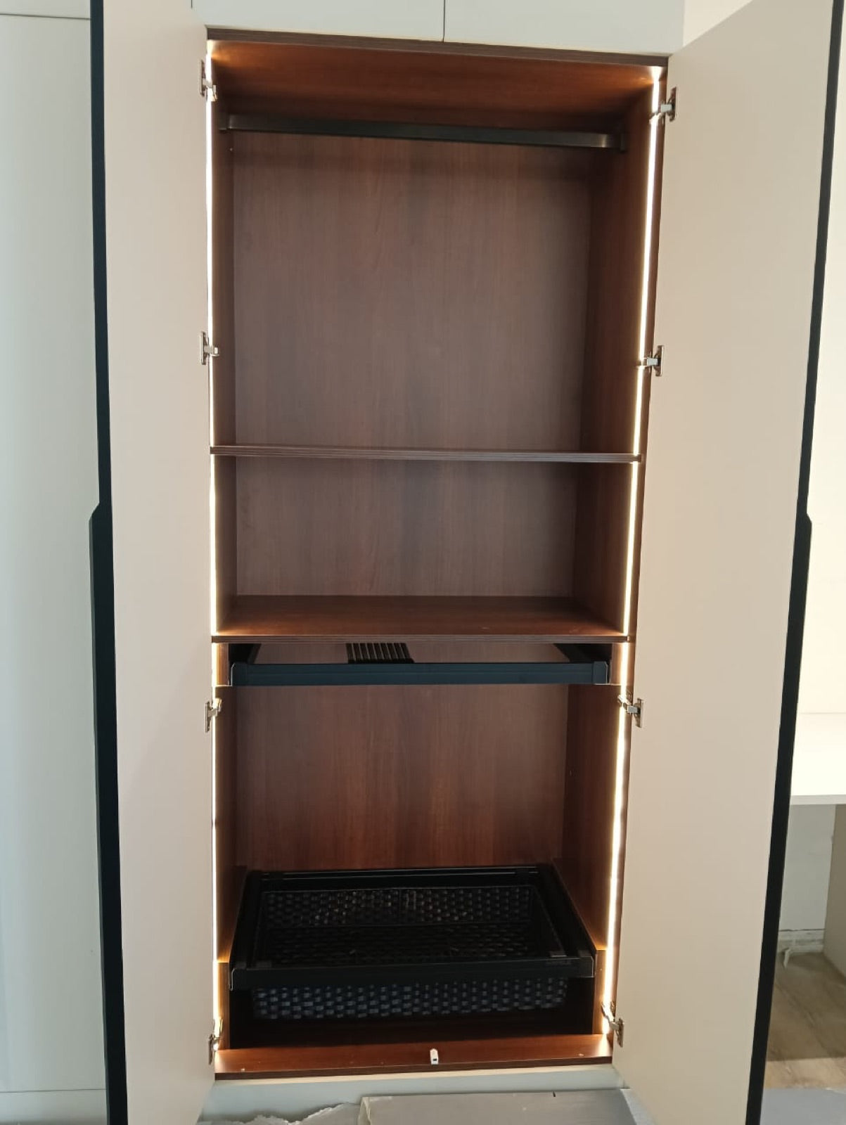 Wardrobe interior · lit shelving with pull-out mesh basket drawer