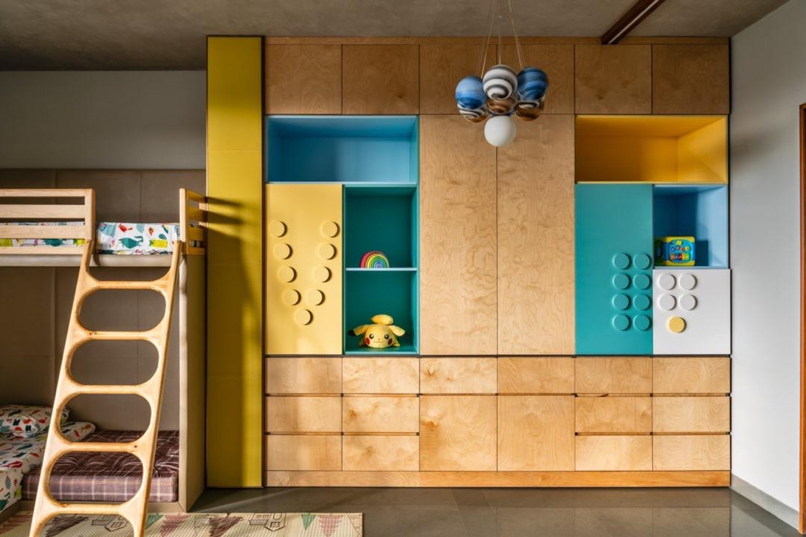 Kids' bedroom with a bunk bed beside a birch-ply storage unit.